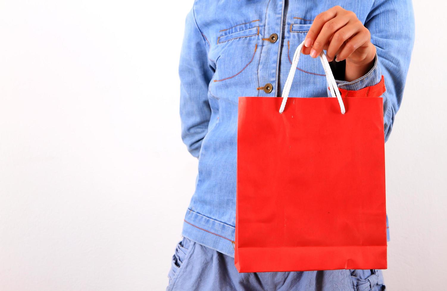Young model with shopping bag in hands photo