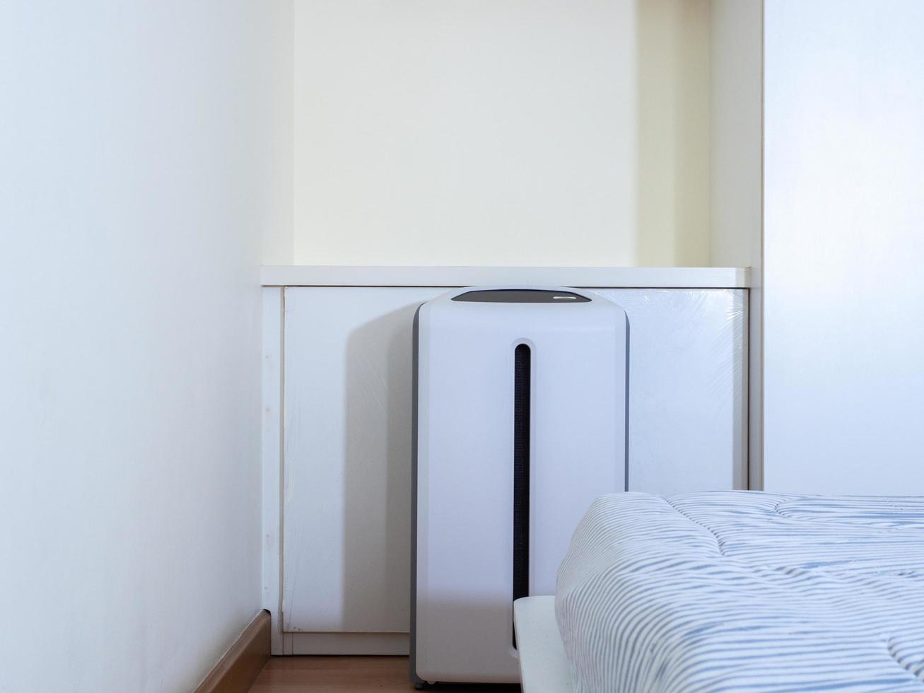 air purifier in bed room. air cleaner removing fine dust in house photo