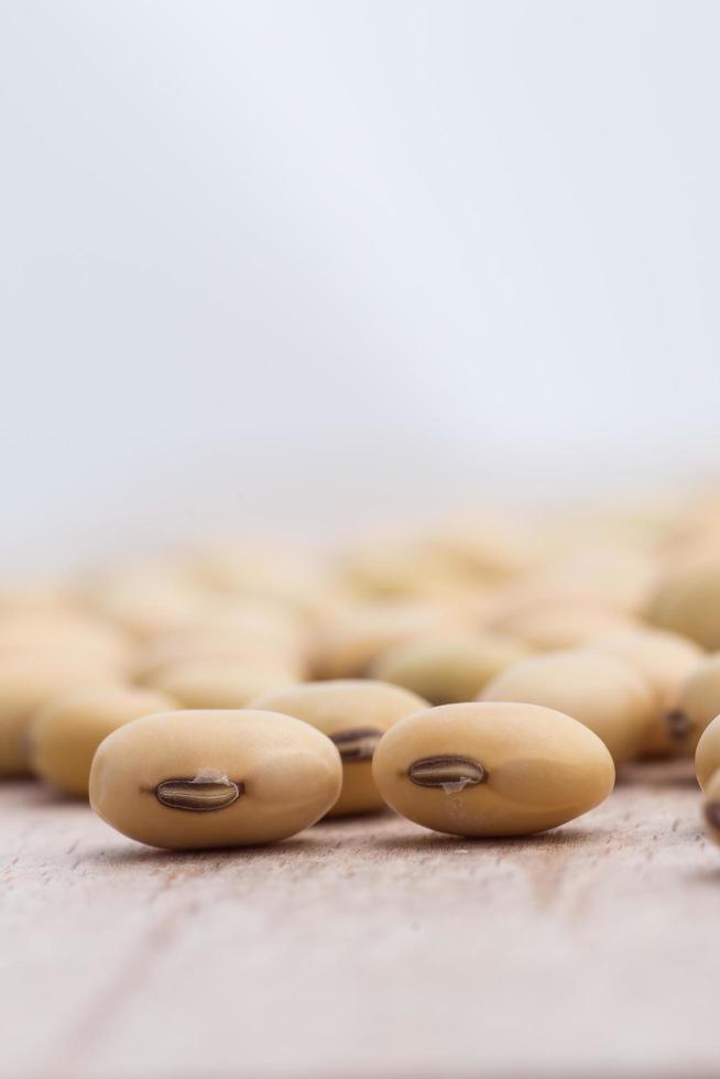 Soy beans on wood background photo