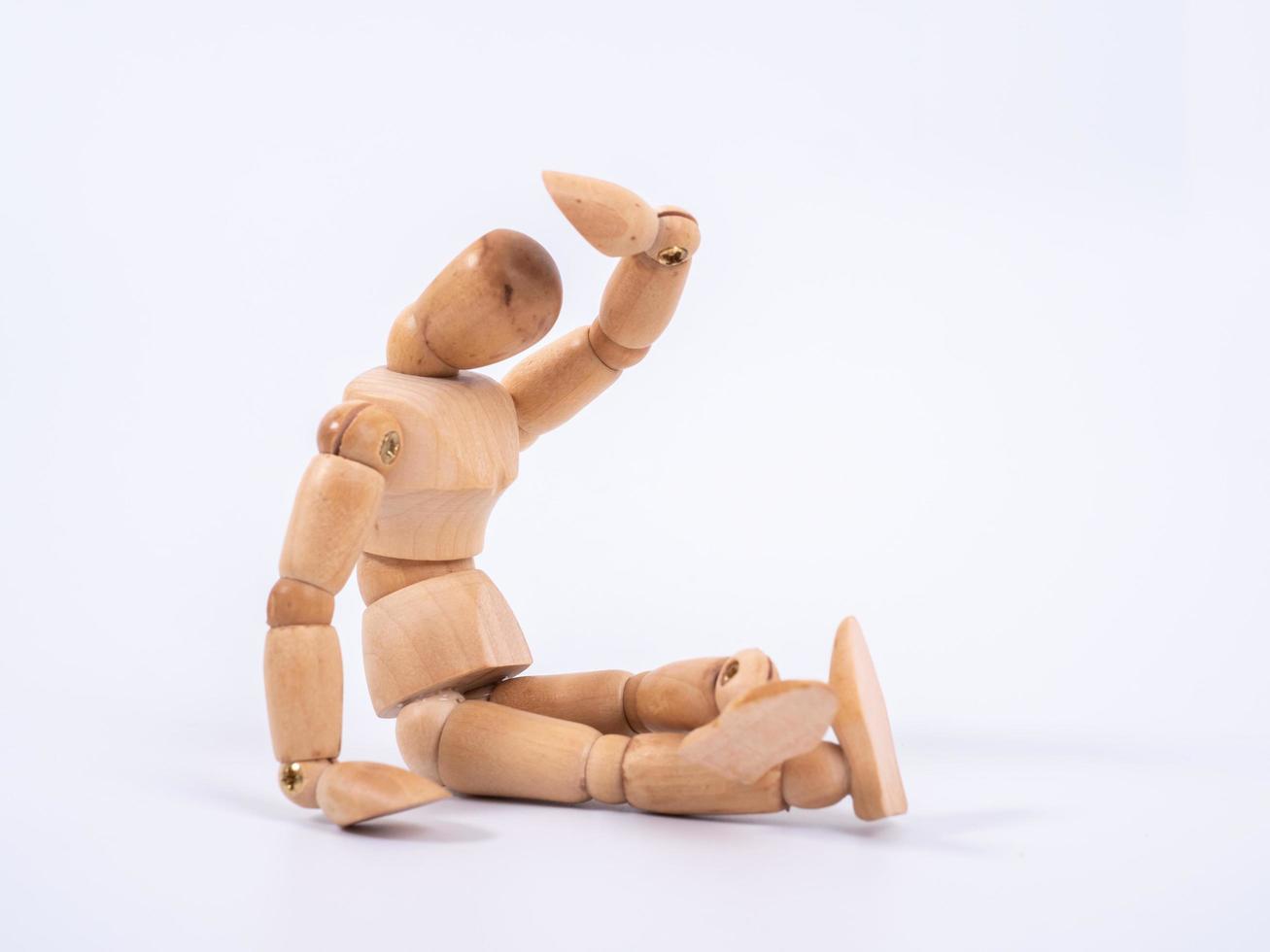 The wooden dummy sits on white background photo