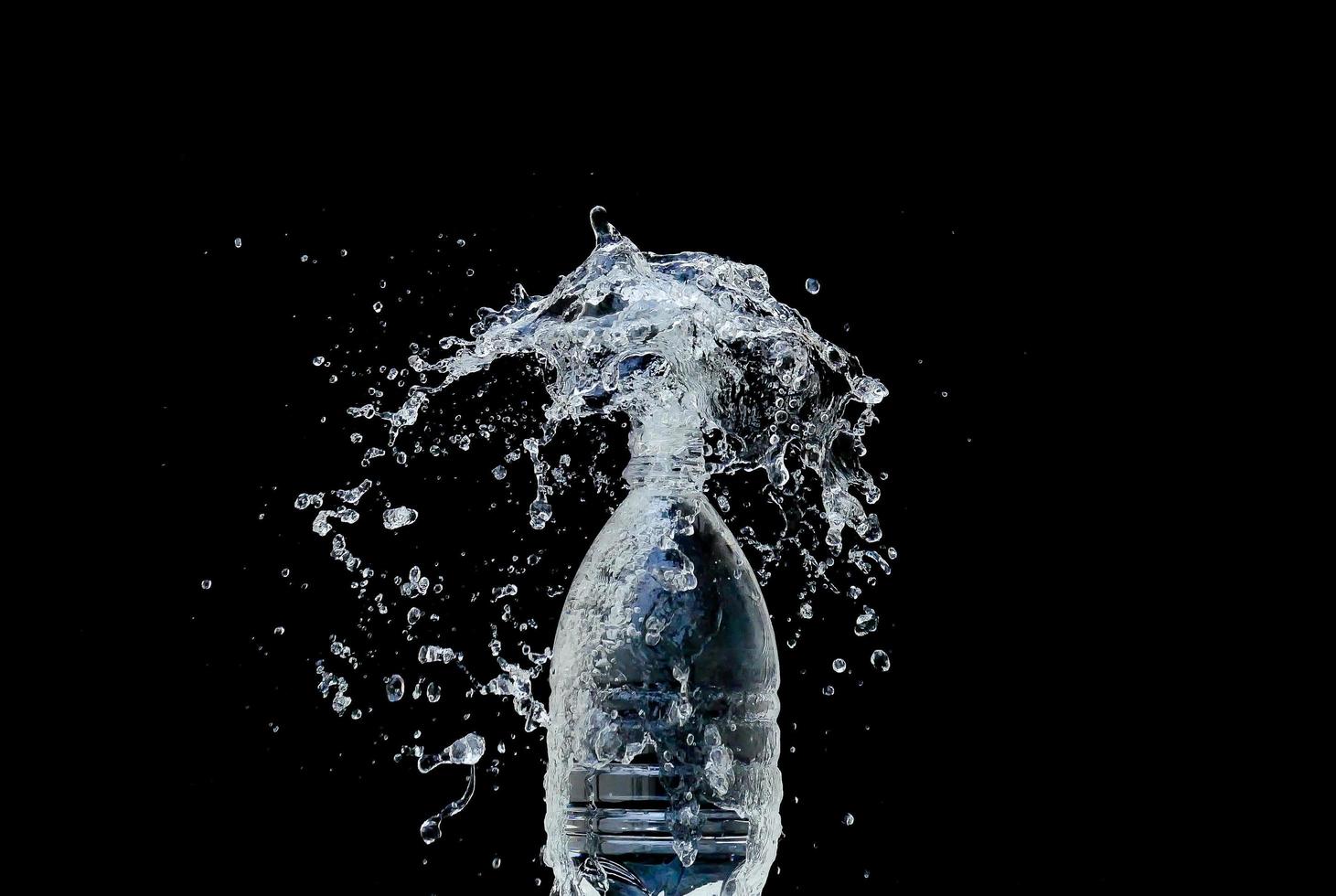 Abstract water jet crashes on a black background photo