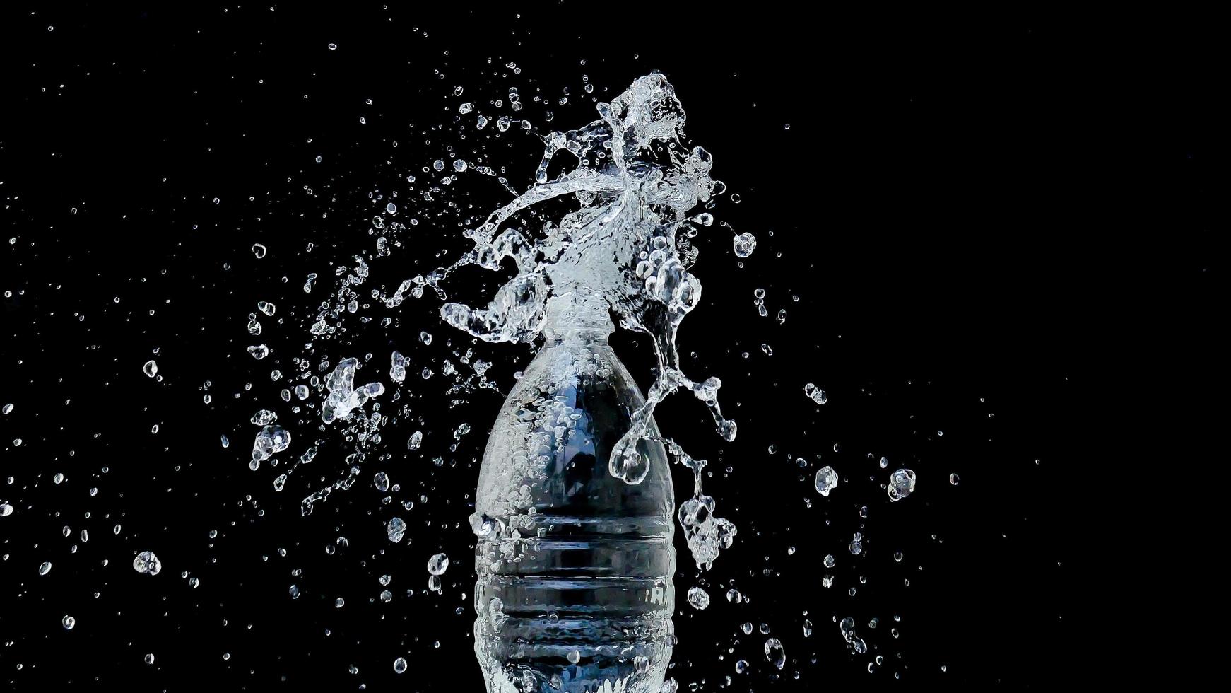 Abstract water jet crashes on a black background photo