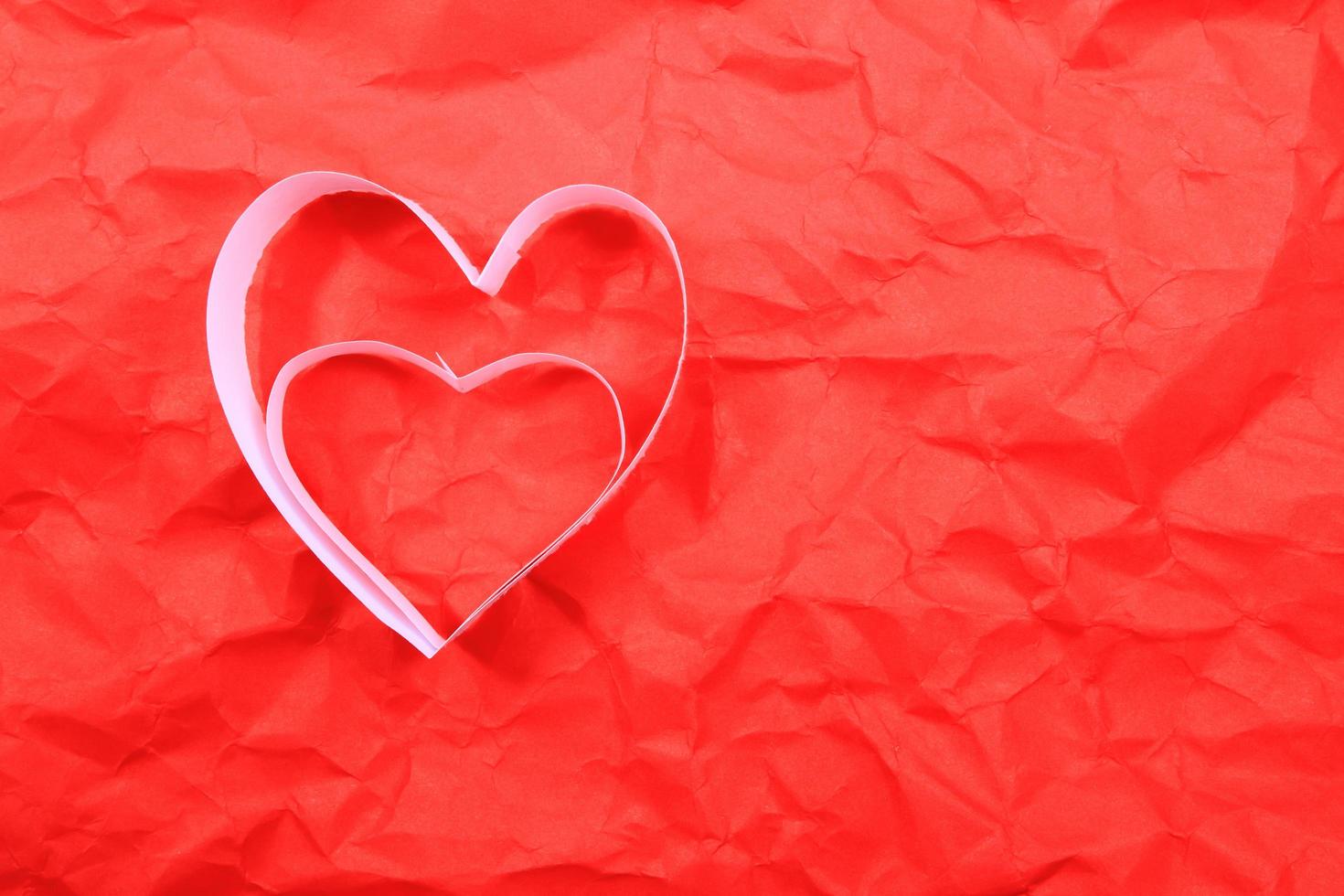 Paper hearts on red background photo