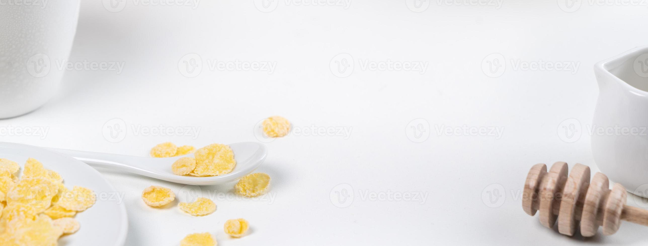 Corn flakes bowl sweeties with milk and orange on white background, close up, fresh and healthy breakfast design concept. photo