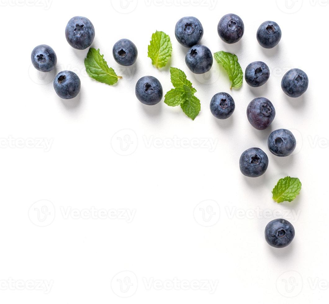 Blueberry fruit top view isolated on a white background, flat lay overhead layout with mint leaf, healthy design concept. photo