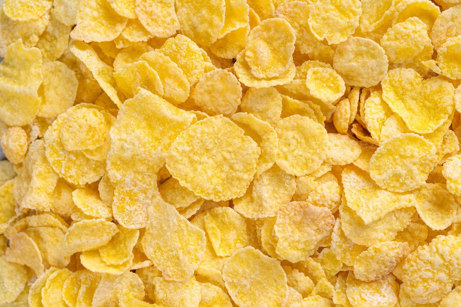 Corn flakes bowl sweets on gray cement background, top view flat lay layout design, fresh and healthy breakfast concept. photo