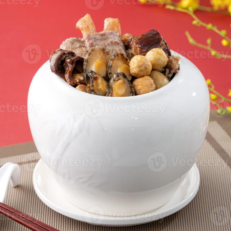Traditional food of Chinese lunar new year, Buddha jumps over the wall, Chinese Soup Casserole dish, Buddha's Temptation, named Fo Tiao Qiang, close up. photo