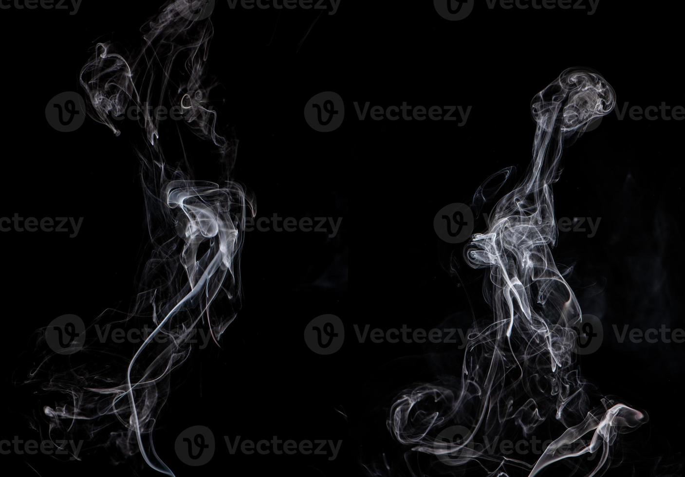 Conceptual image of white color smoke isolated on dark black background, Halloween design element concept. photo
