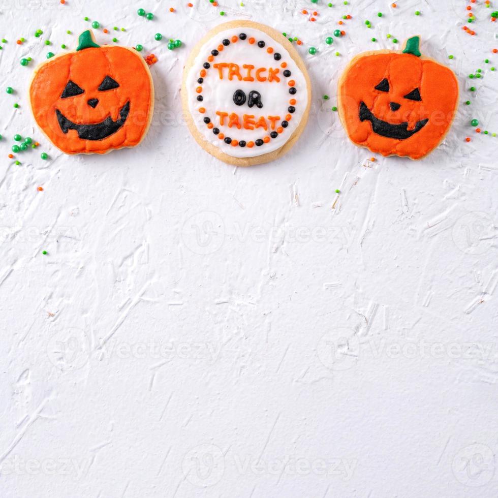 Top view of Halloween festive decorated icing sugar cookies on white background. photo