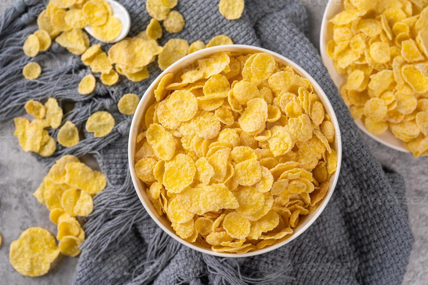 Corn flakes bowl sweets on gray cement background, top view flat lay layout design, fresh and healthy breakfast concept. photo