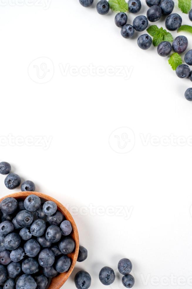 Blueberry fruit top view isolated on a white background, flat lay overhead layout with mint leaf, healthy design concept. photo