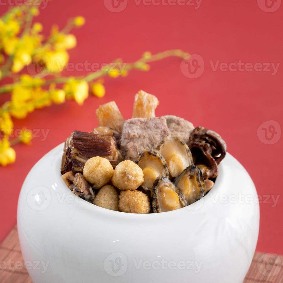 Traditional food of Chinese lunar new year, Buddha jumps over the wall, Chinese Soup Casserole dish, Buddha's Temptation, named Fo Tiao Qiang, close up. photo