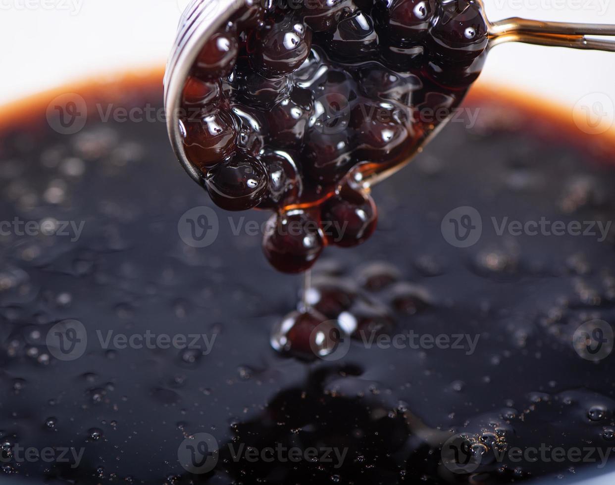 Cooking, boiling brown sugar flavor tapioca pearl balls, ingredient of bubble tea, preparing food and drink, close up, recipe cookbook steps design concept. photo