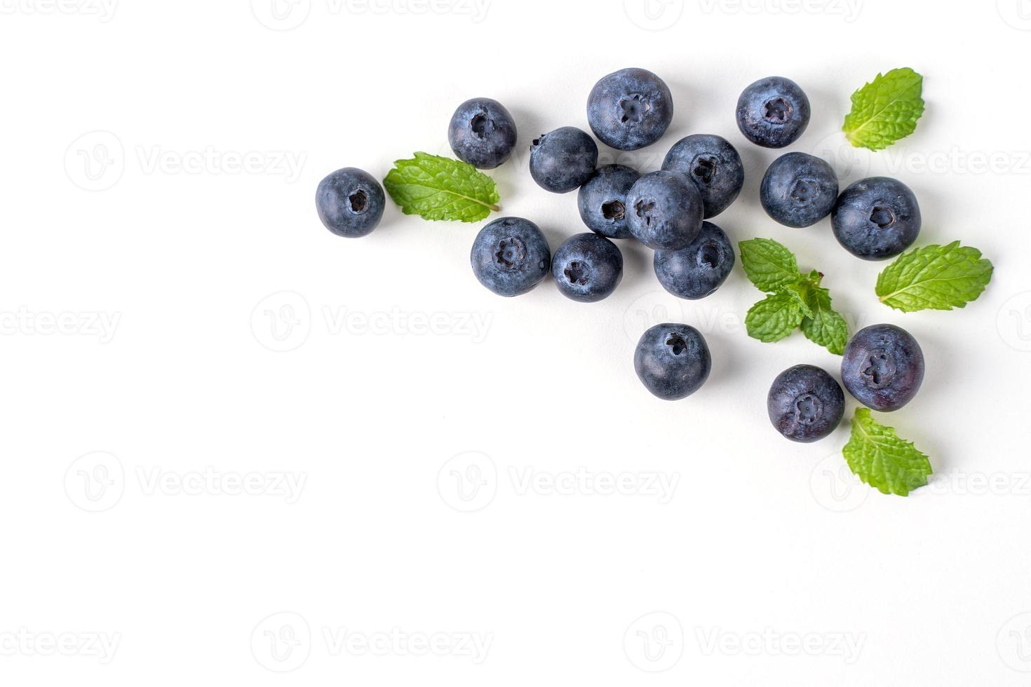 Blueberry fruit top view isolated on a white background, flat lay overhead layout with mint leaf, healthy design concept. photo