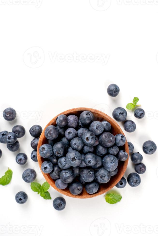 Blueberry fruit top view isolated on a white background, flat lay overhead layout with mint leaf, healthy design concept. photo