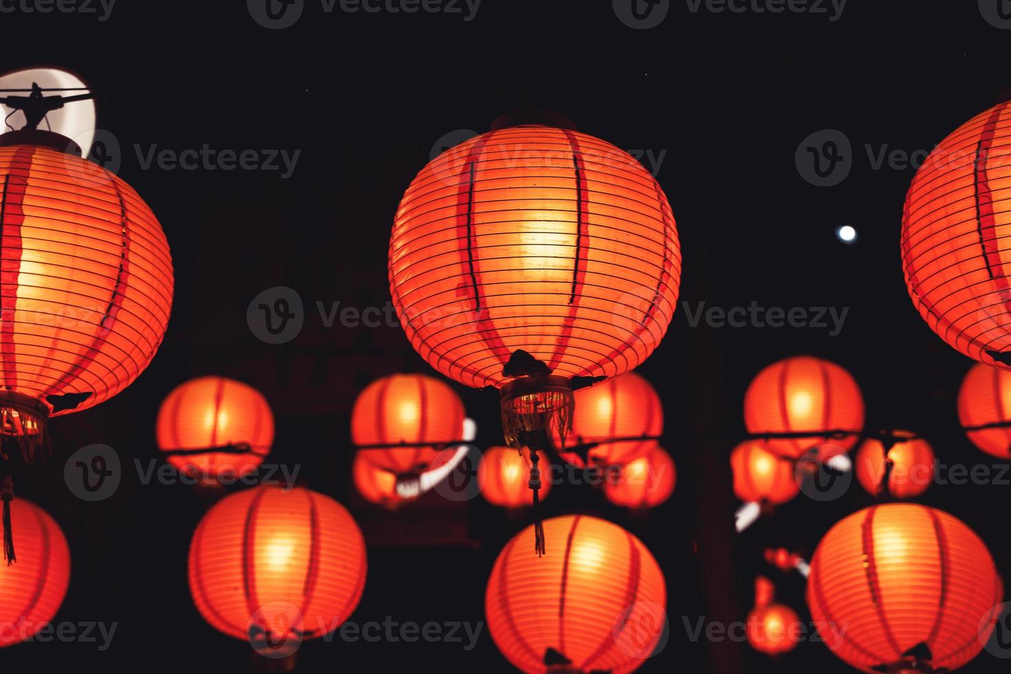 Beautiful round red lantern hanging on old traditional street, concept of Chinese lunar new year festival in Taiwan, close up. The undering word means blessing. photo