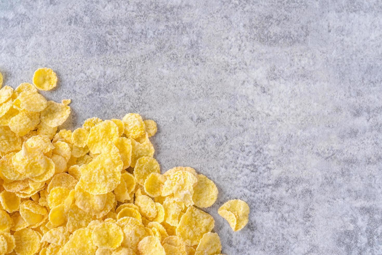 Corn flakes bowl sweets on gray cement background, top view flat lay layout design, fresh and healthy breakfast concept. photo