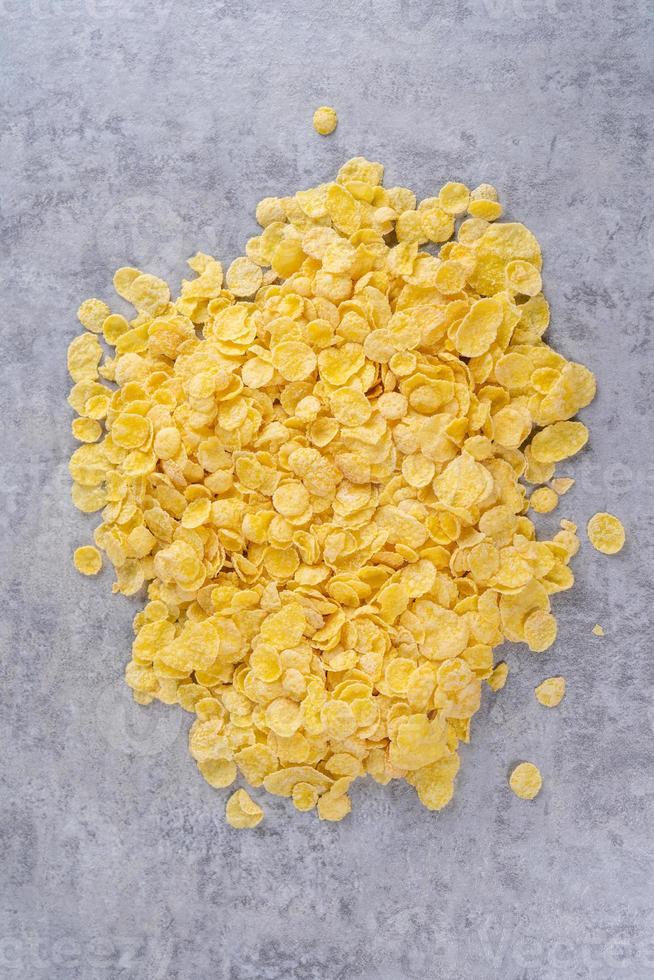 Corn flakes bowl sweets on gray cement background, top view flat lay layout design, fresh and healthy breakfast concept. photo