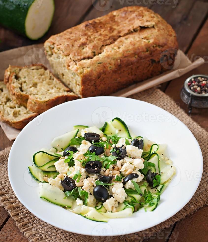 Zucchini salad with feta, olives and pine nuts photo