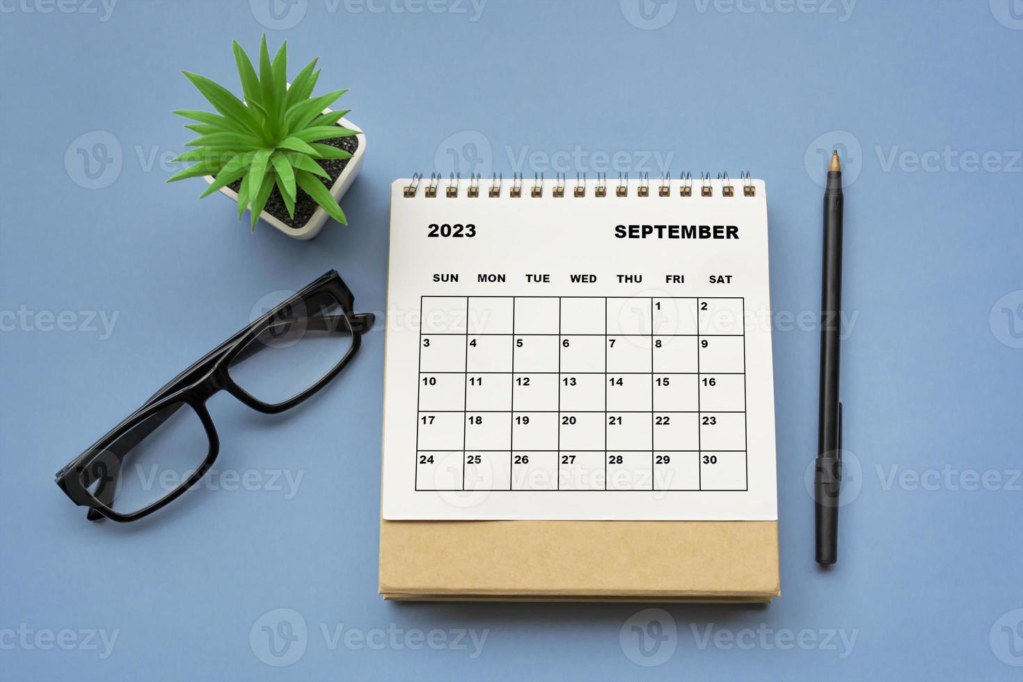 September 2023 desk calendar on blue background. Directly above. photo