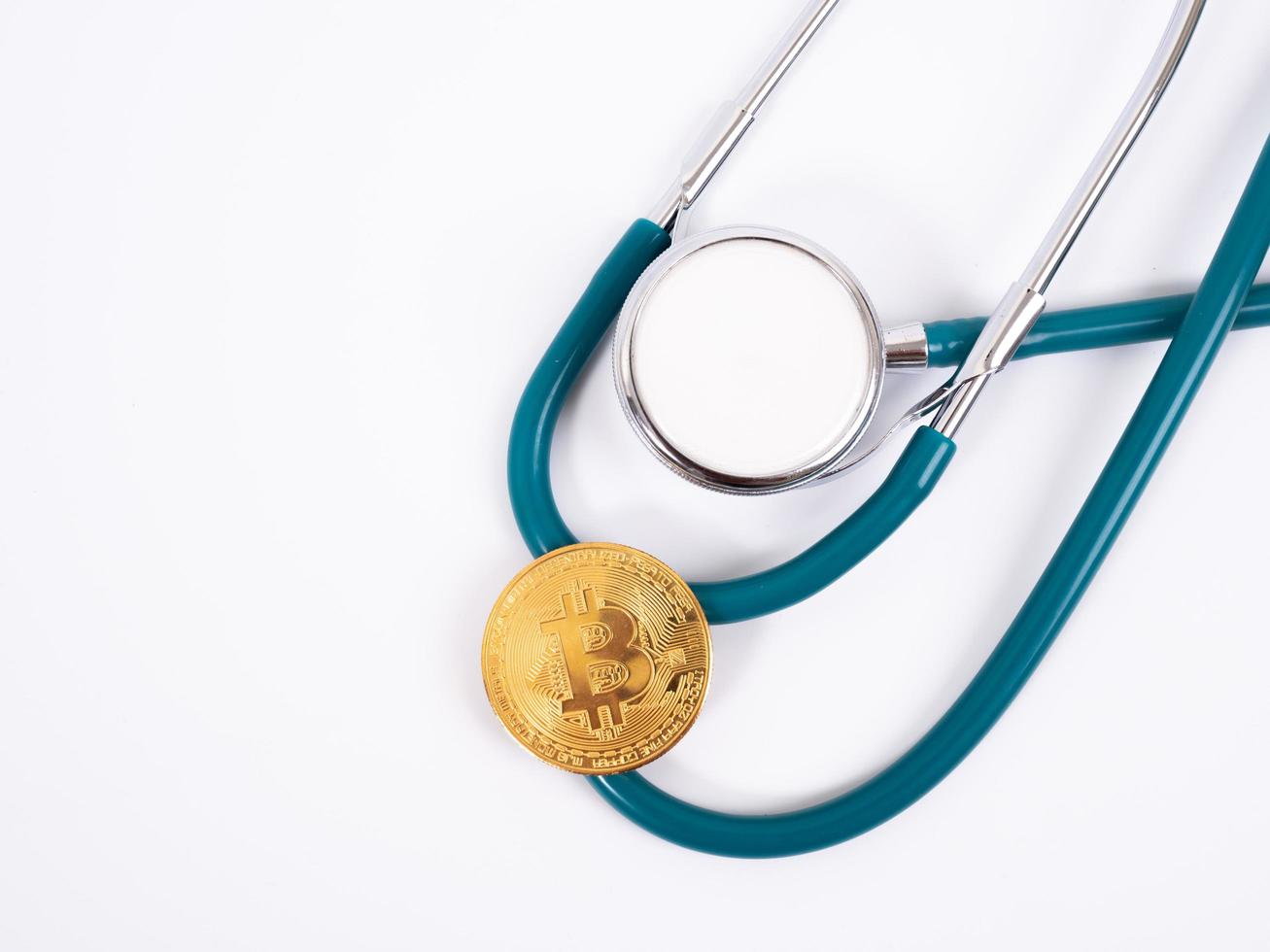 Cryptocurrency medical concept with a gold bitcoin coin photo