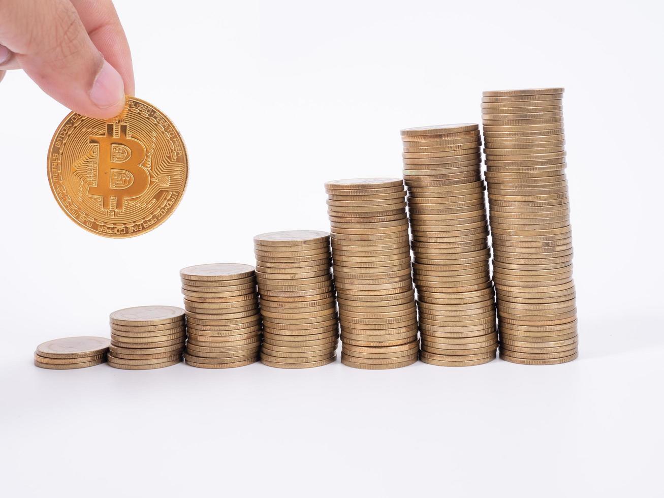 Man's hand put money coins to stack of  cryptocurrency. Money, Financial, Business Growth concept photo