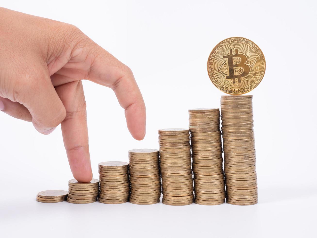 Man's hand put money coins to stack of  cryptocurrency. Money, Financial, Business Growth concept photo