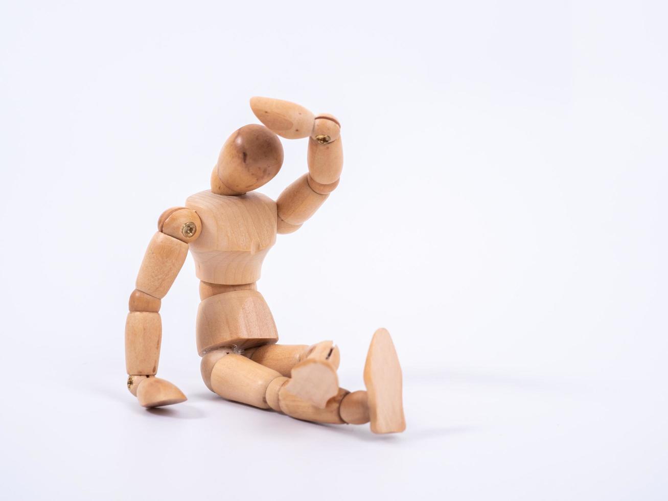 The wooden dummy sits on white background photo