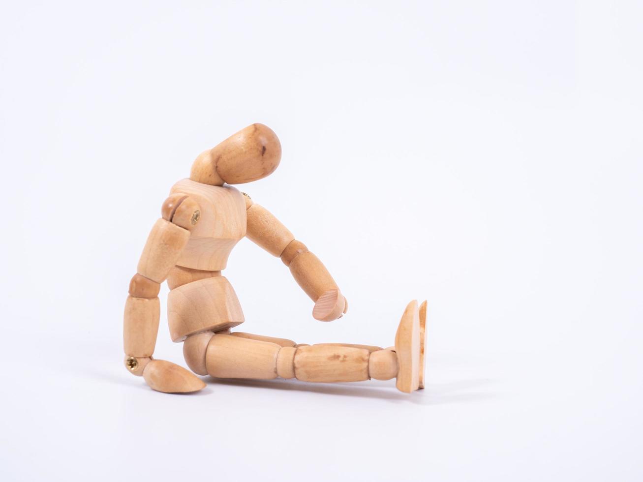 The wooden dummy sits on white background photo