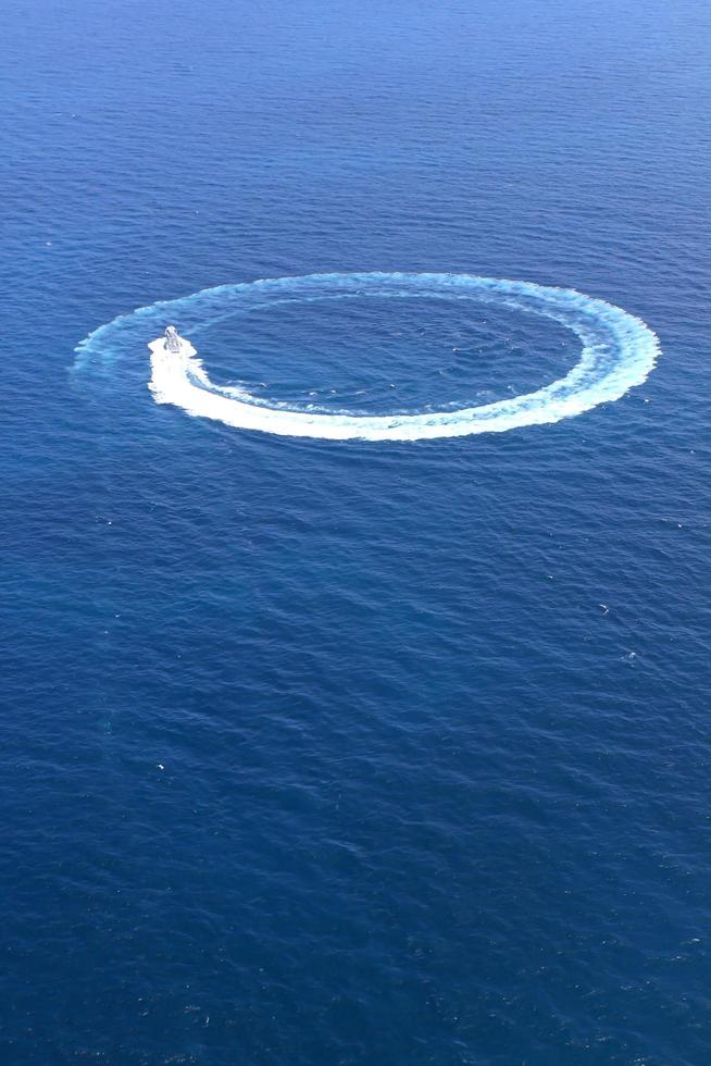 Speedboat in the sea ran circles. photo