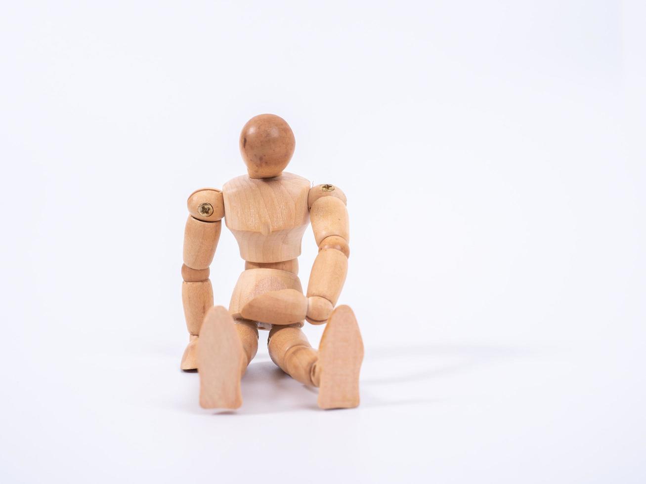 The wooden dummy sits on white background photo