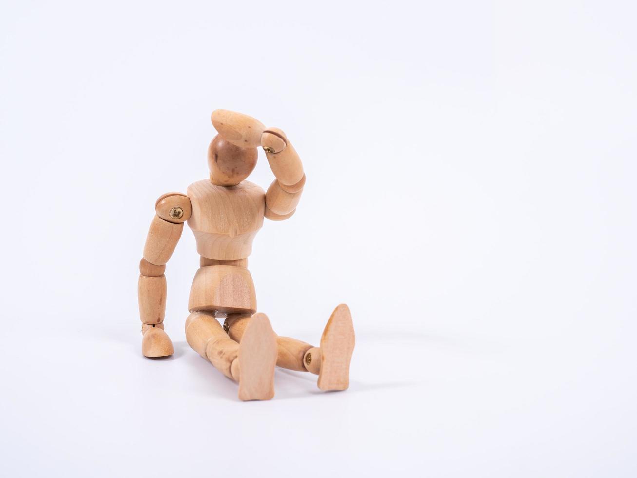 The wooden dummy sits on white background photo