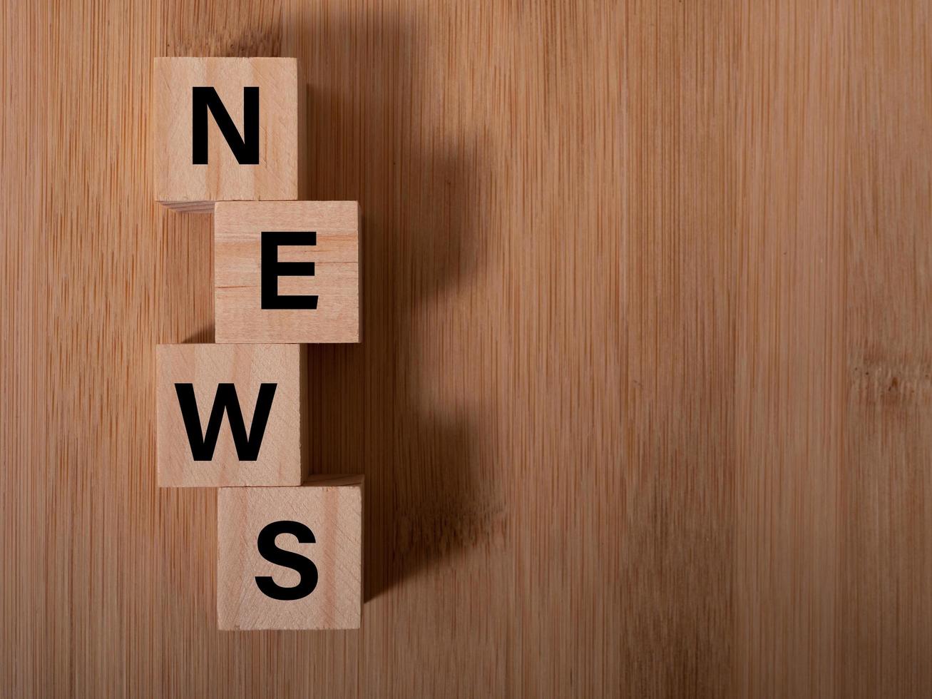 Wooden news sign on a table in an office photo