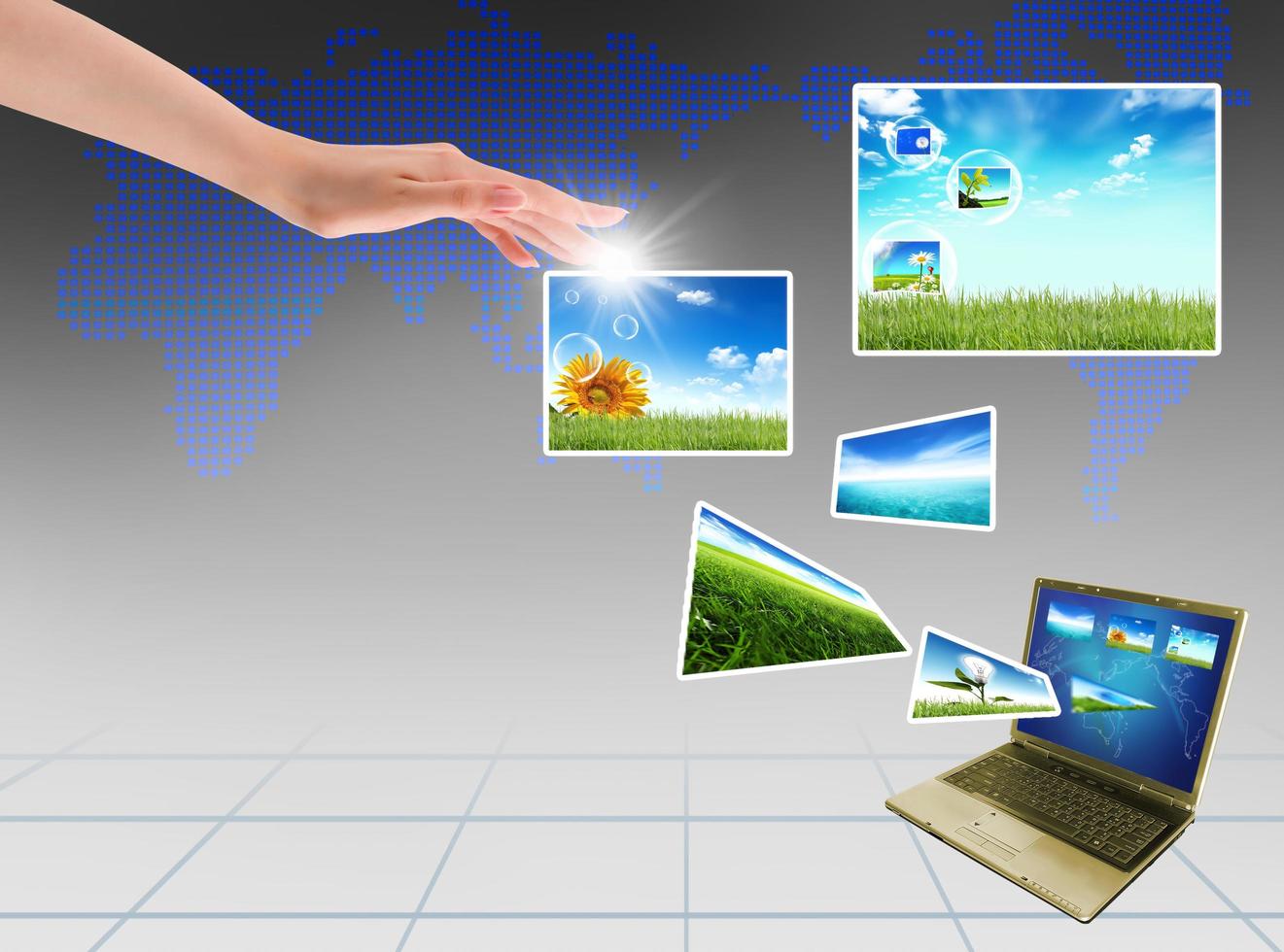 Multimedia concept with modern laptop on green field. photo