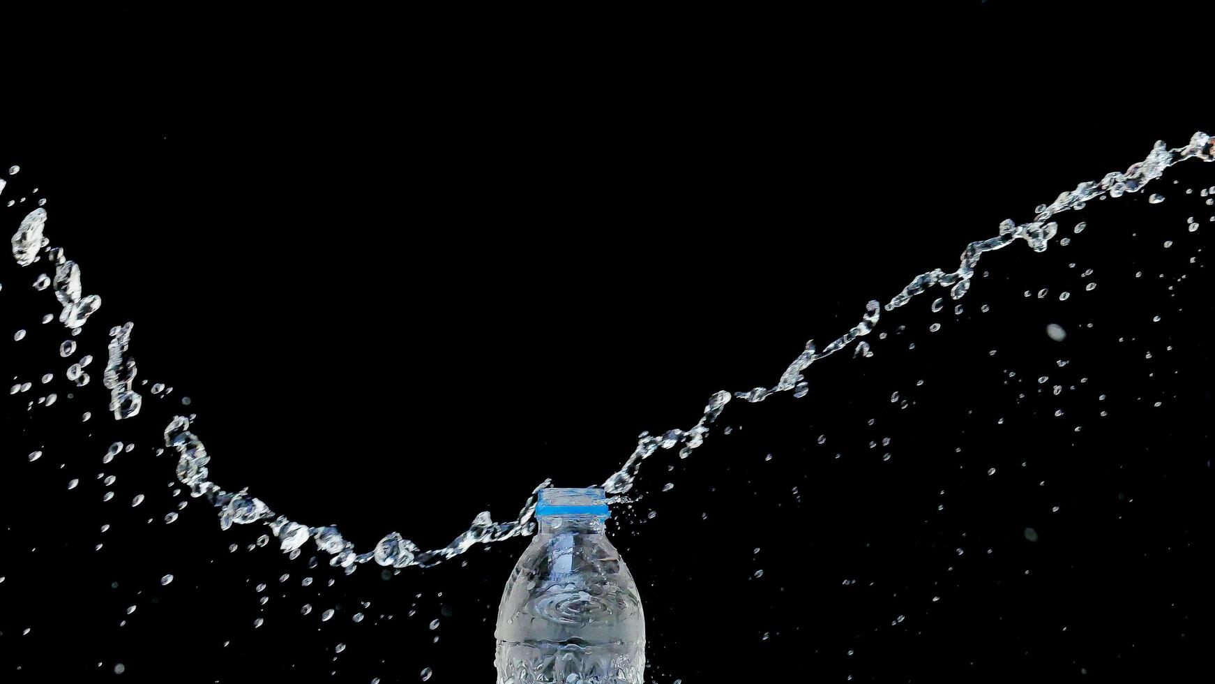 Abstract water jet crashes on a black background photo