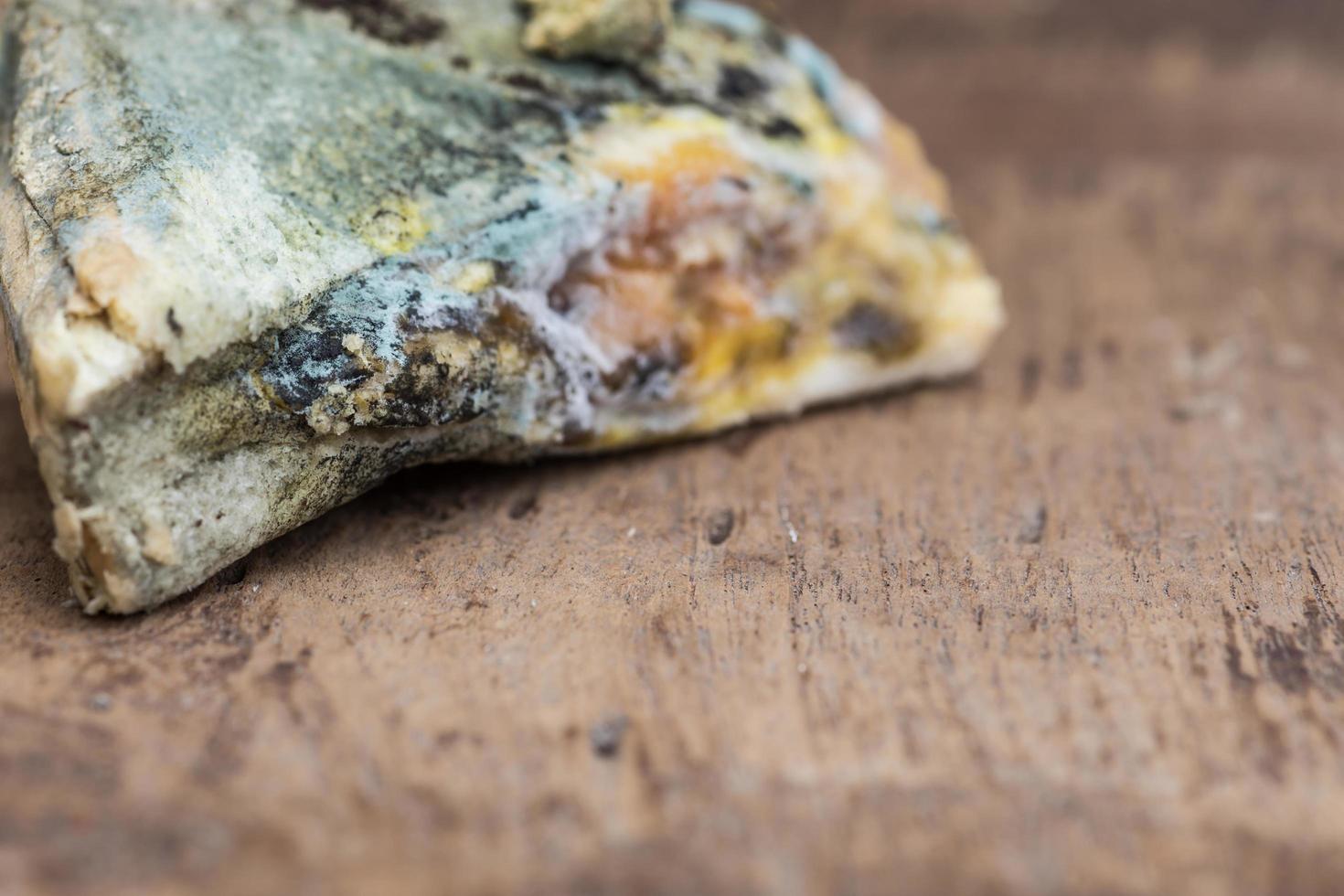 Mouldy bread on cutting board photo
