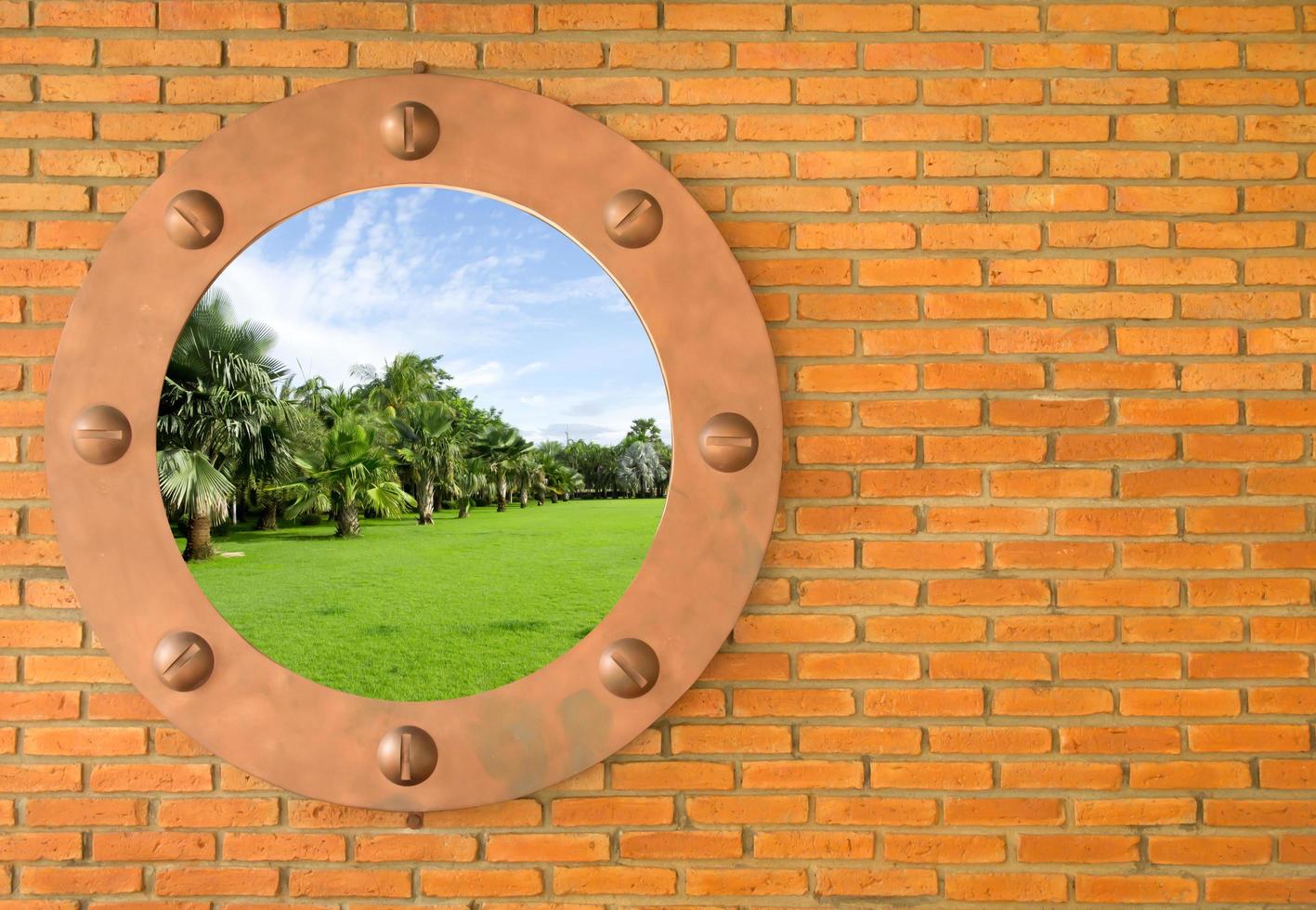 Blue sky in hole in old wall, brick frame photo