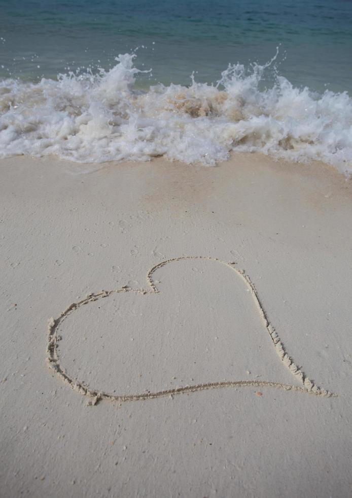 hearts drawn on the sand of a beach photo