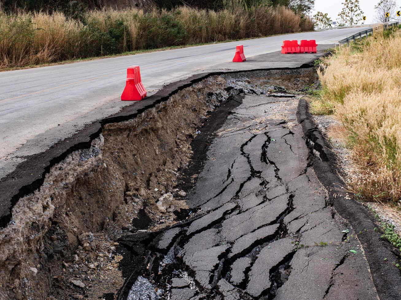 Cracked surface of an asphalt road photo