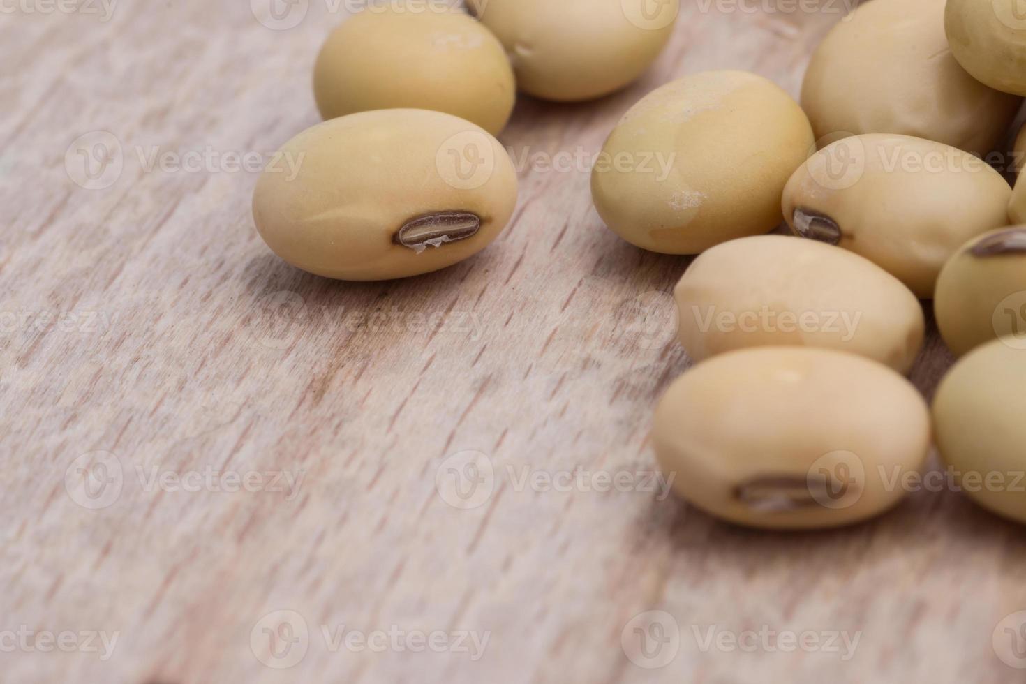 Soy beans on wood background photo