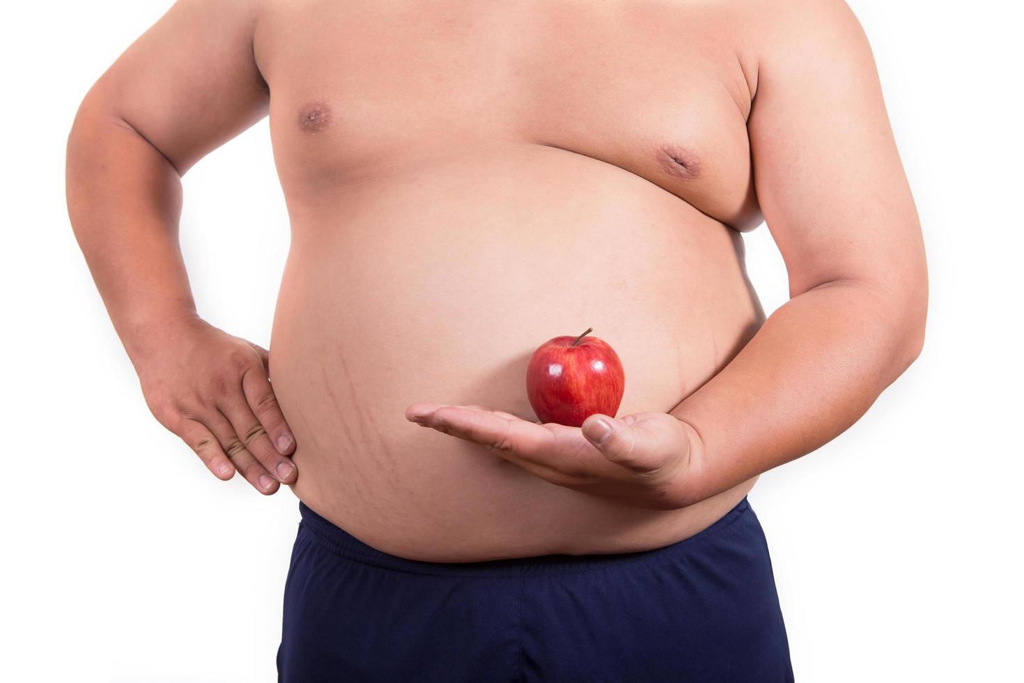 hombre gordo con una manzana en la mano foto