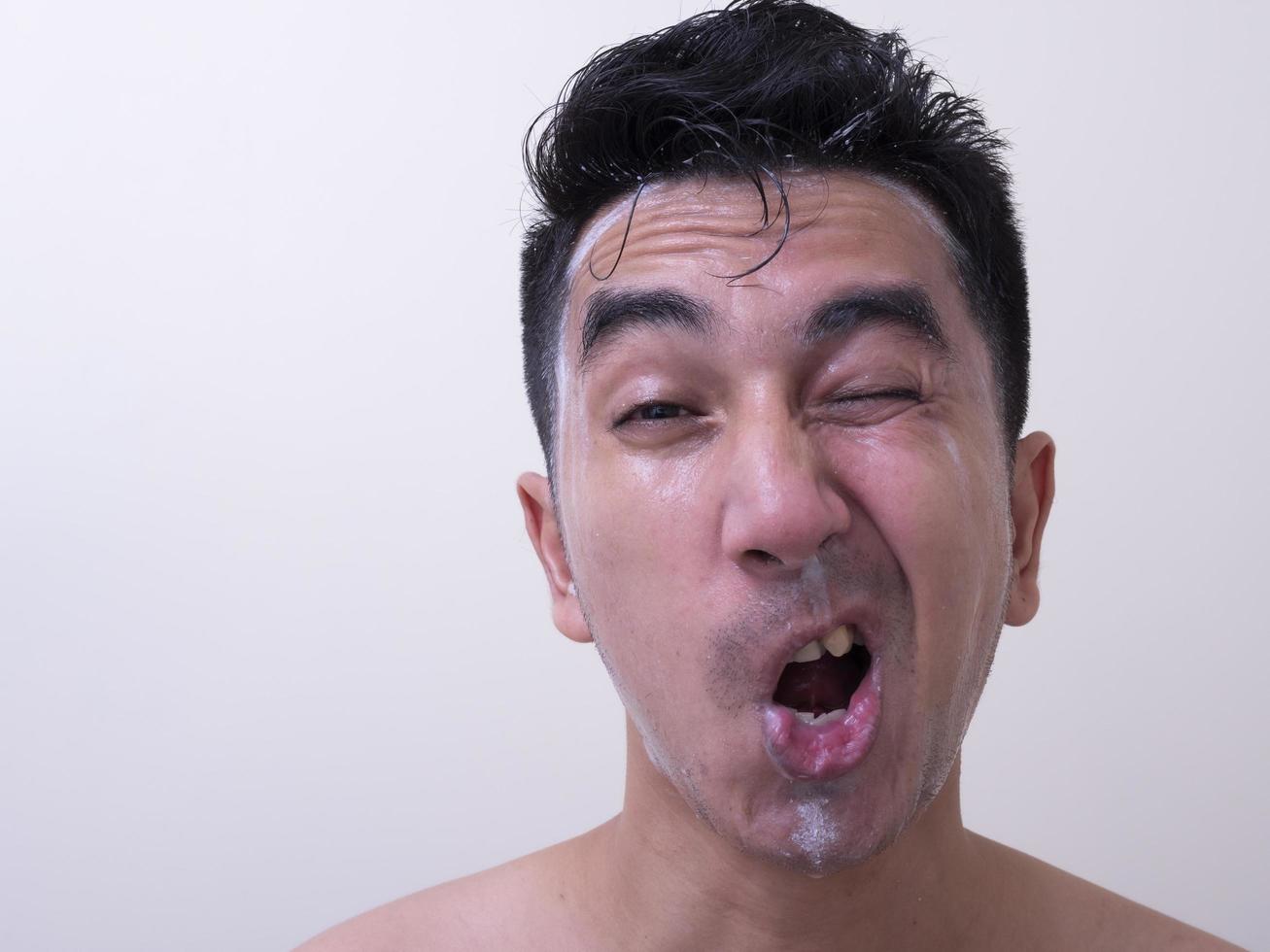 Asian men are washing their face with foam , Men skin care concept photo