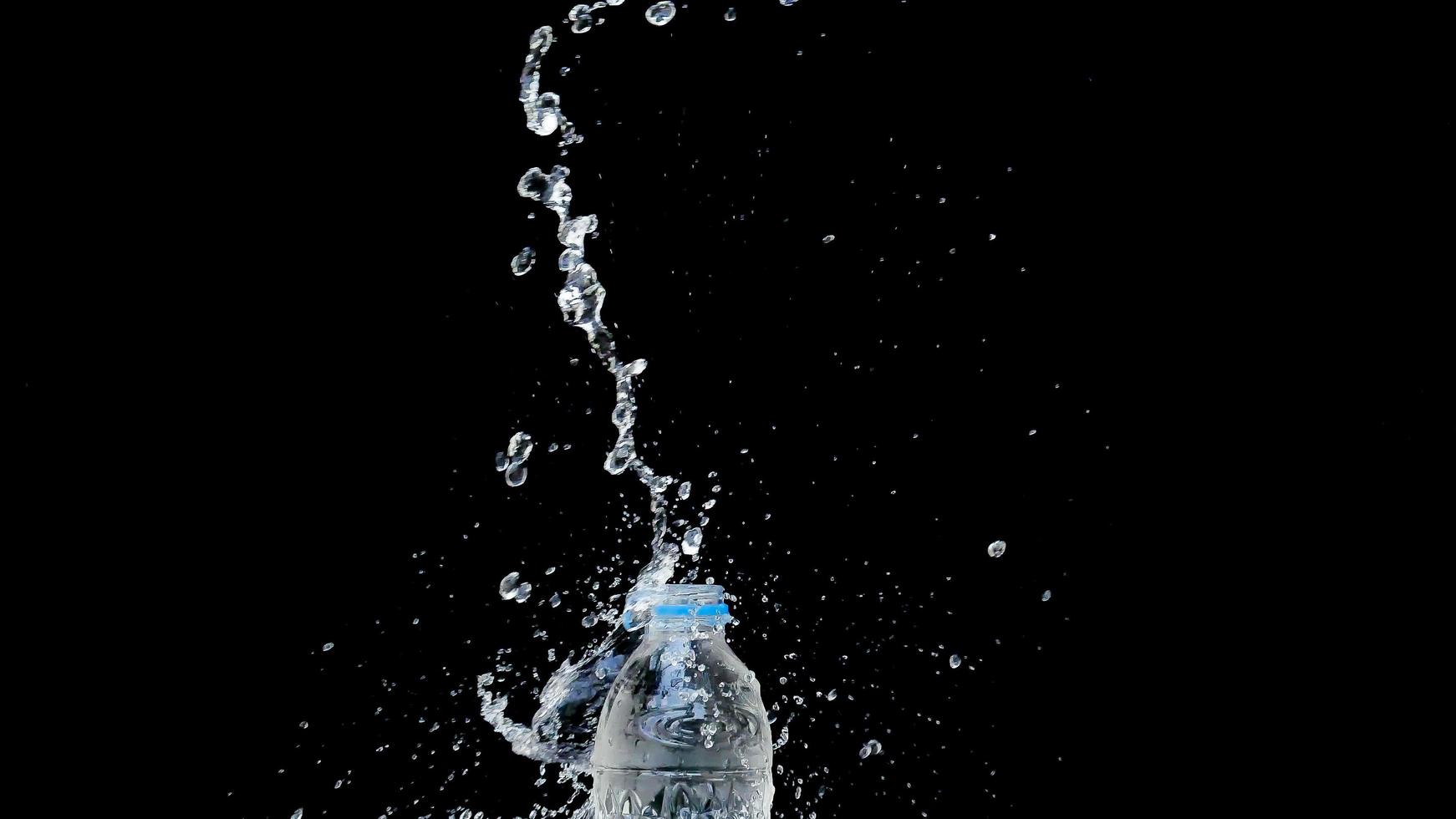 Abstract water jet crashes on a black background photo