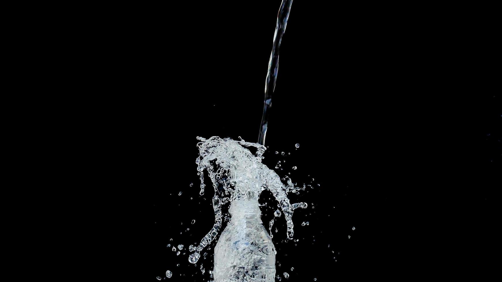 Abstract water jet crashes on a black background photo
