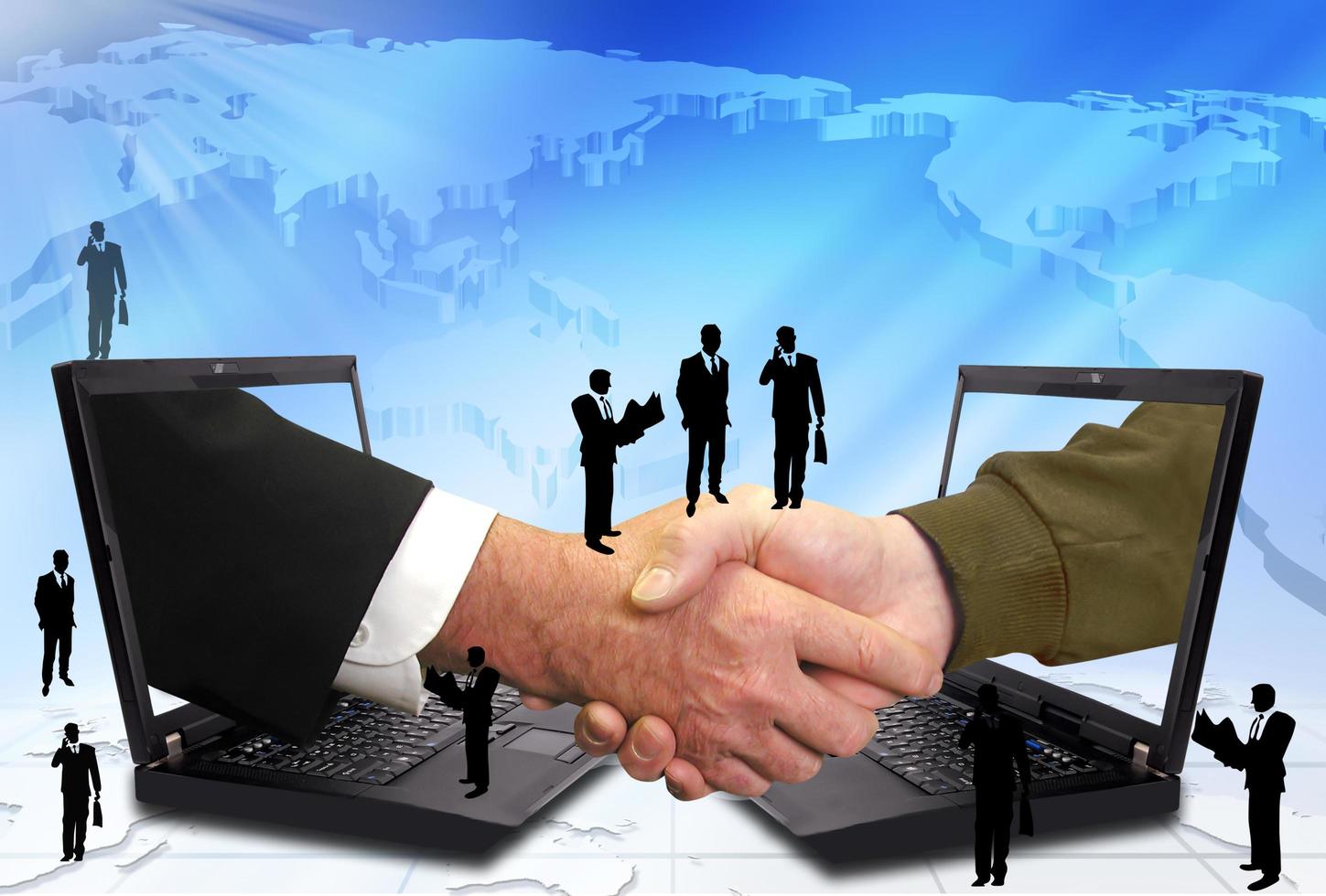 Hand shake between a businessman and a laptop photo
