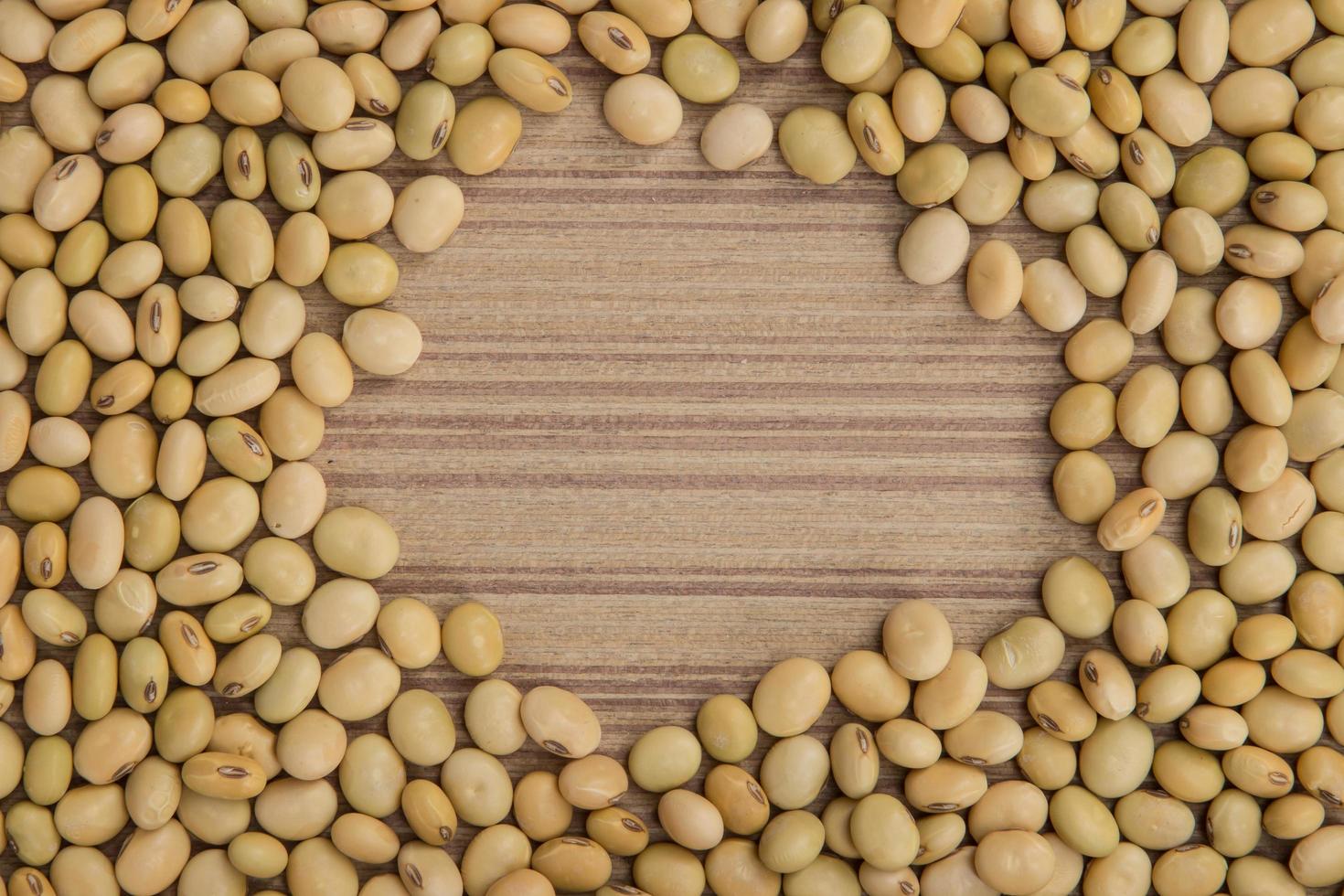 Dry soybeans on wooden board photo