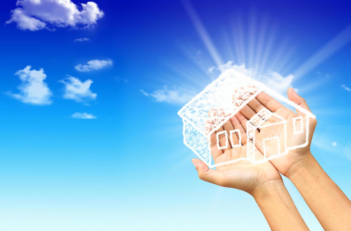 The House in the hands against the blue sky photo