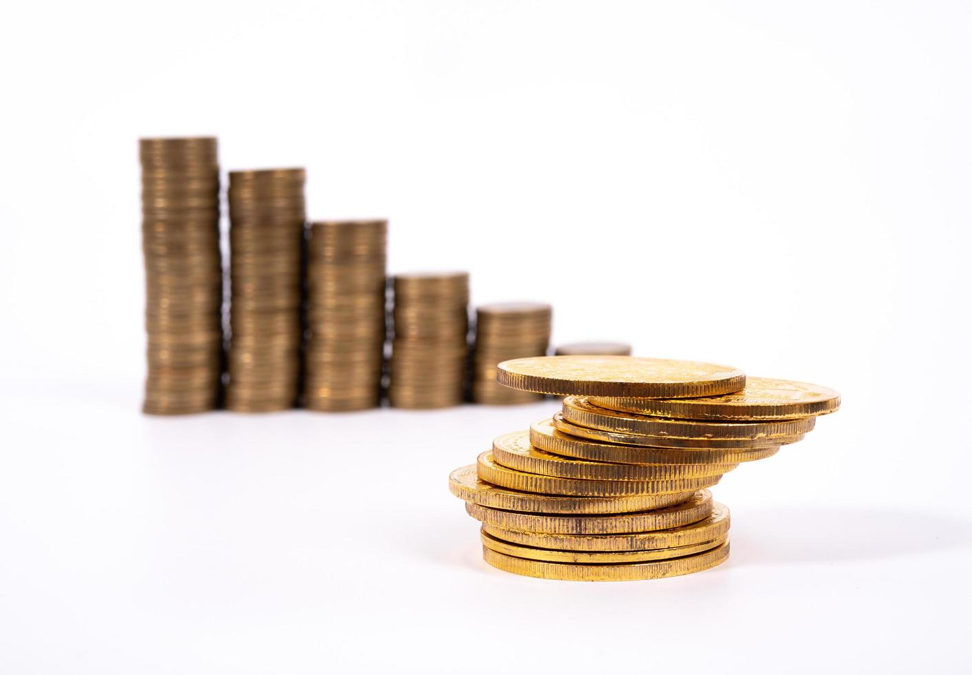 Savings, increasing columns of gold coins isolated on white background photo