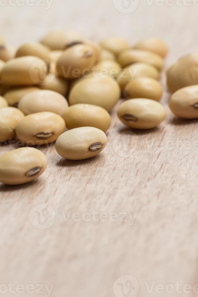 Soy beans on wood background photo