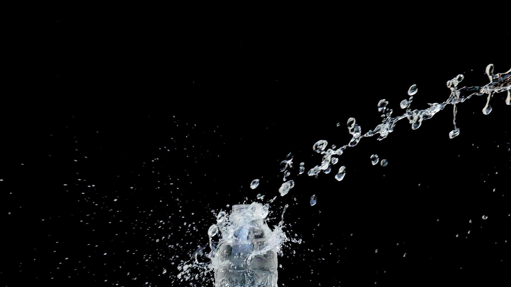 Abstract water jet crashes on a black background photo